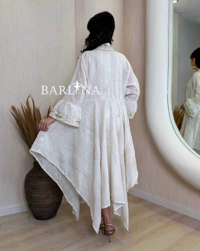 A soft jalabiya with an outer abaya featuring a gold pattern