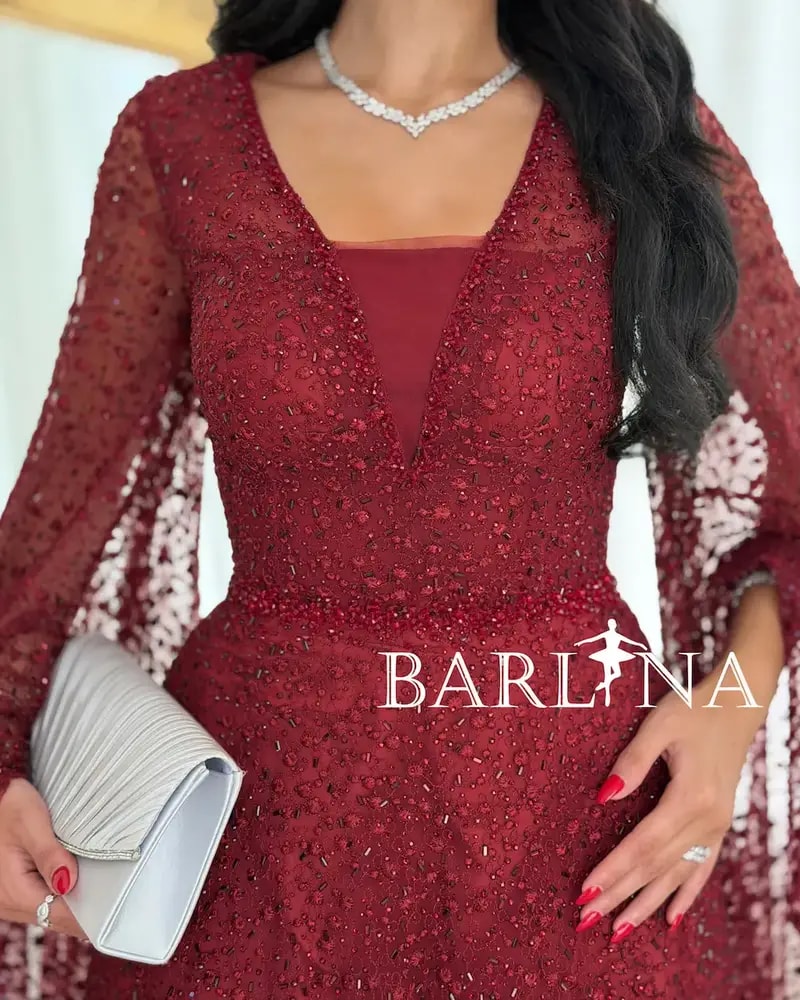 Red evening dress adorned with shimmering embroidery