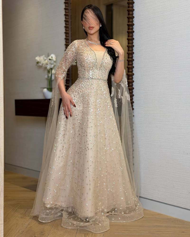 Beige evening dress with sheer draped sleeves