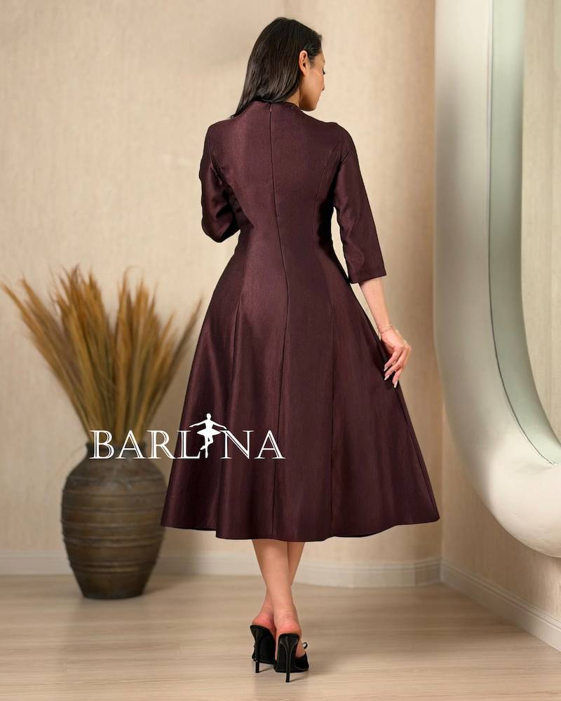 A soft midi dress adorned with a delicate rose