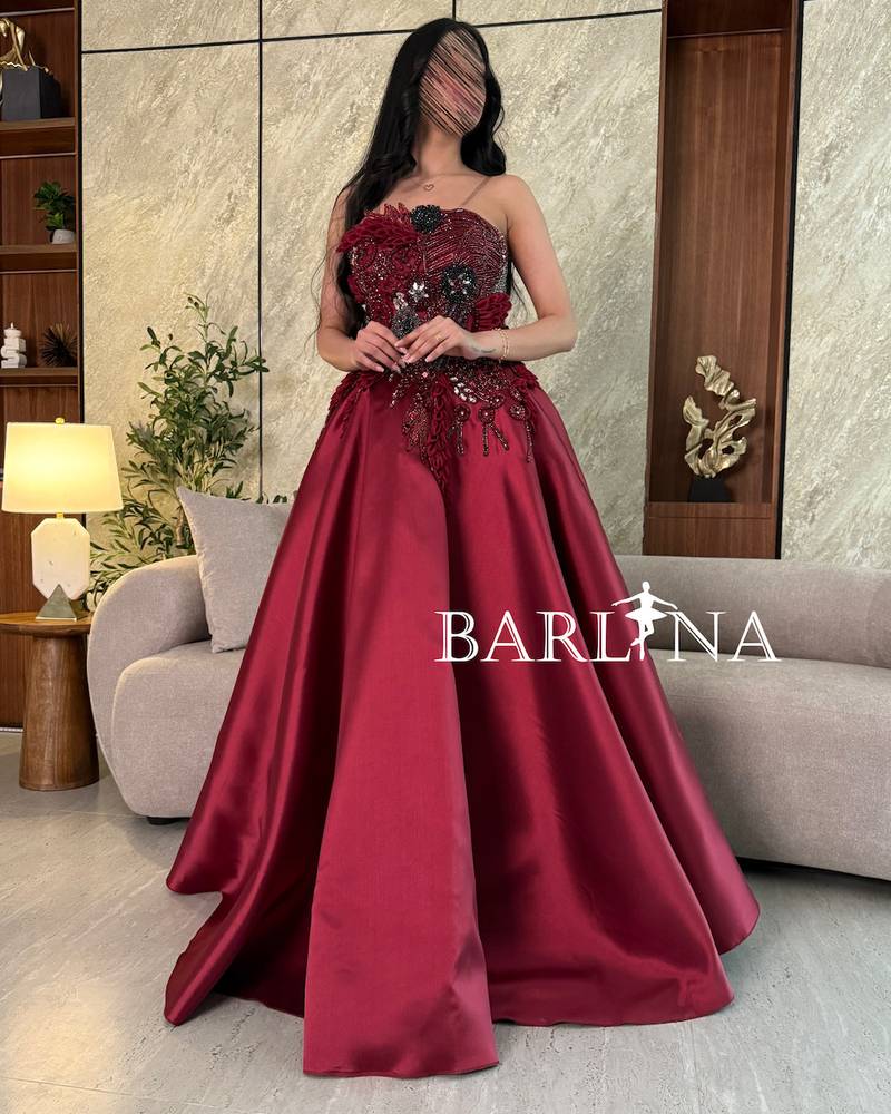 Burgundy dress with prominent beaded and sequin embroidery