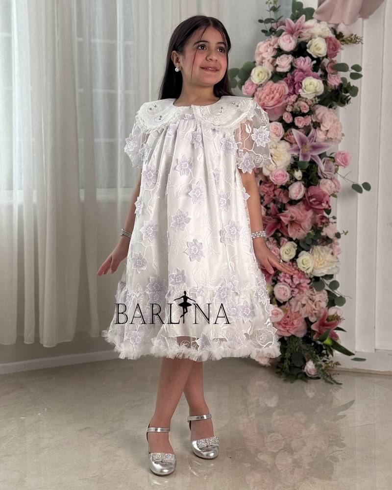 White girl's dress embroidered with purple flowers
