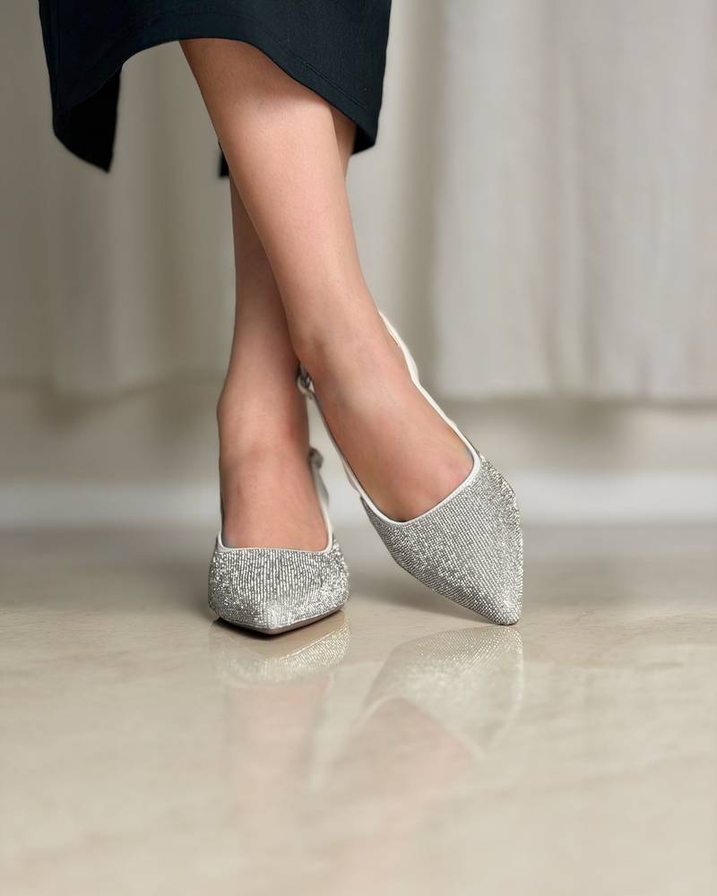 Elegant women's shoes with a thin heel and shiny details