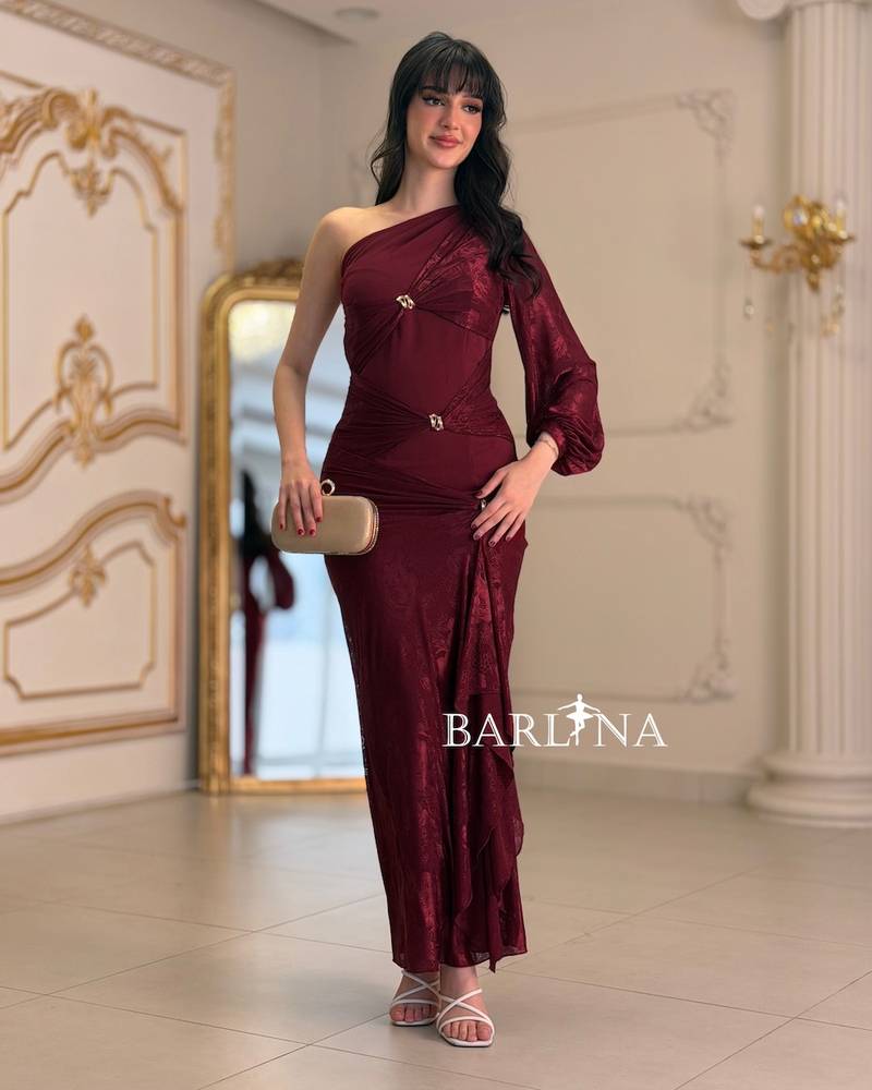 A soft, fitted dress adorned with elegant metallic details.