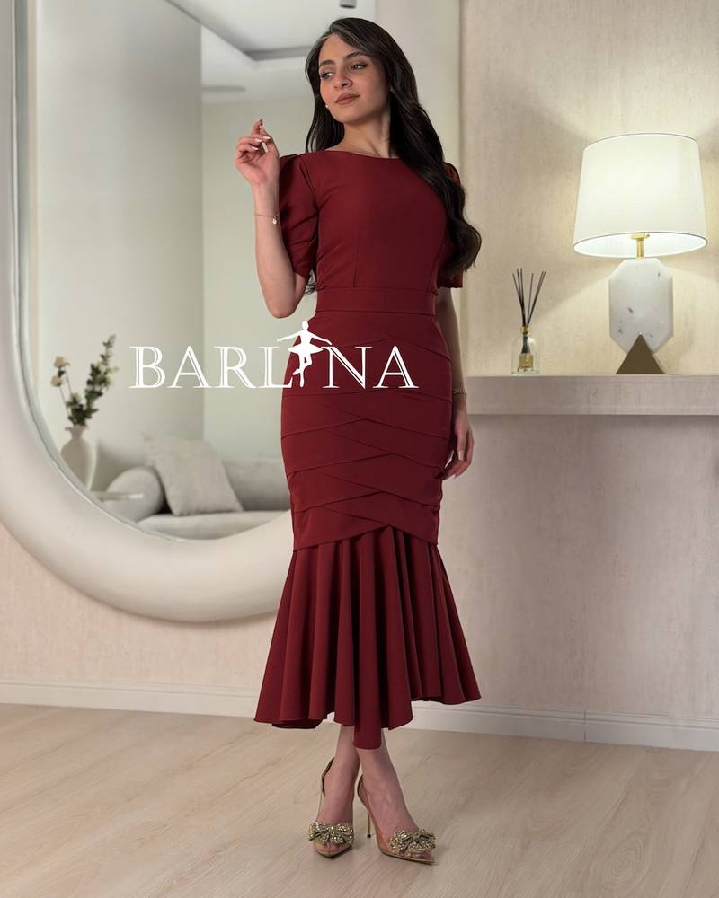 A burgundy mermaid dress with layered tiers