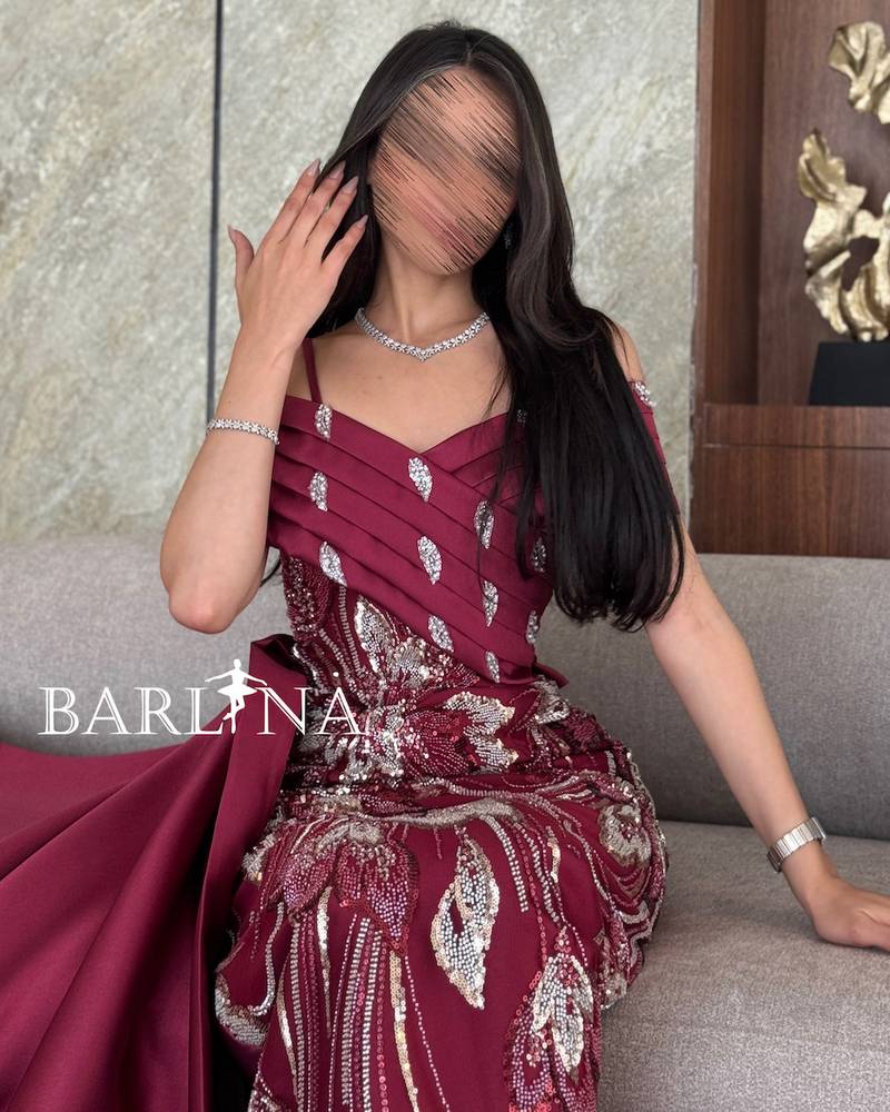 Burgundy dress with shiny embroidery and a back train