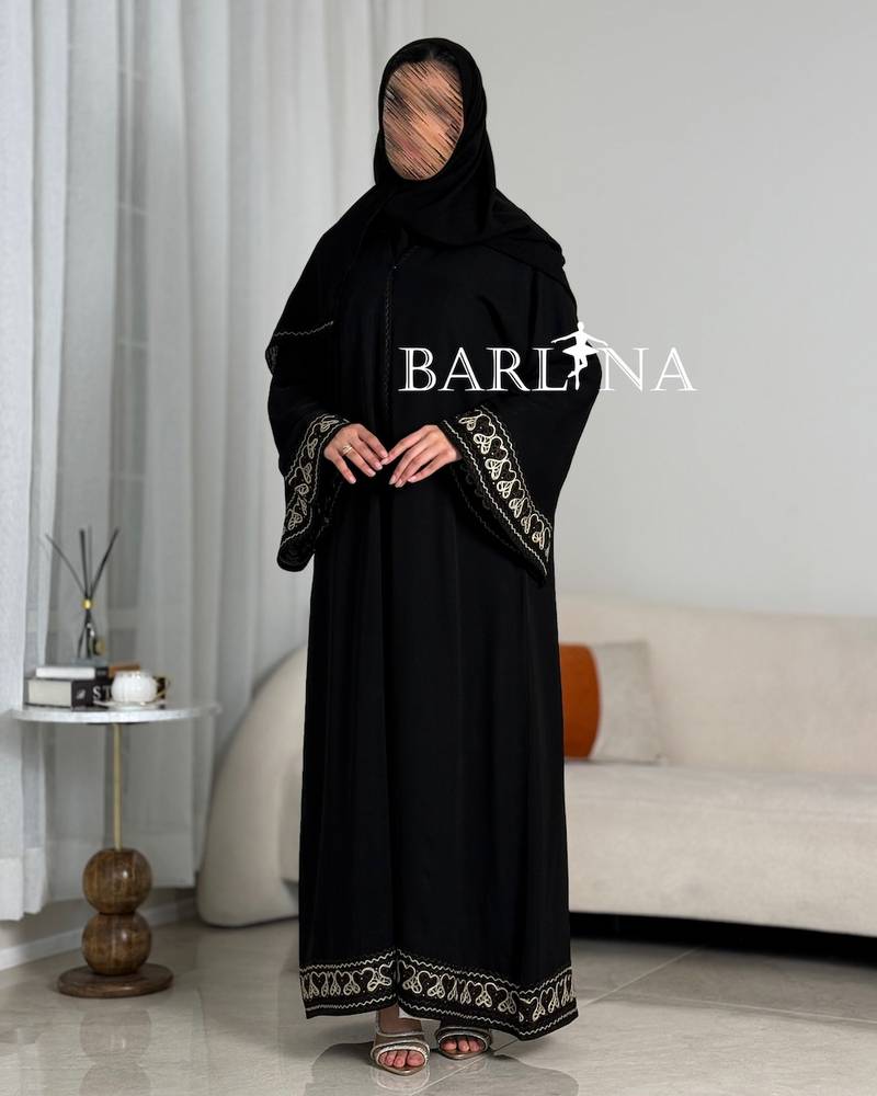 A soft black abaya with prominent beige embroidery
