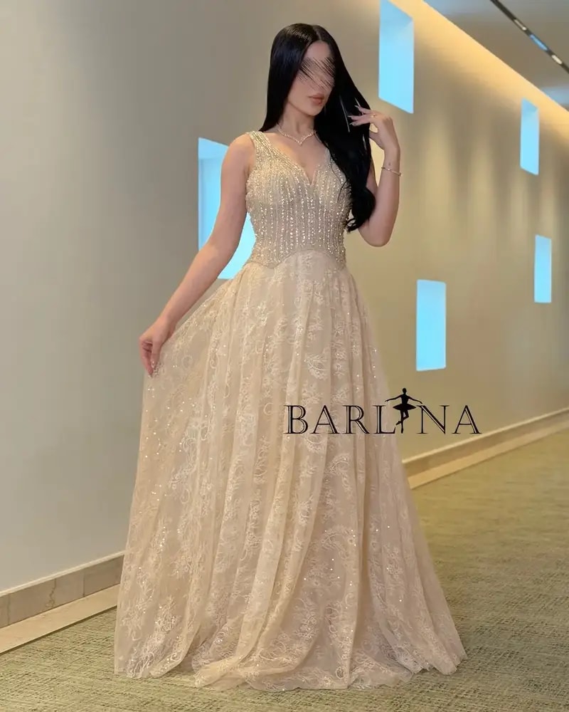 A luxurious flowing beige lace evening dress