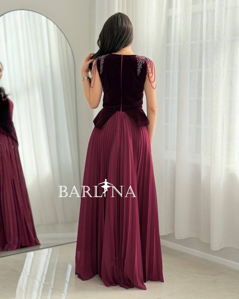 A burgundy dress with a velvet top and a slanted waist.