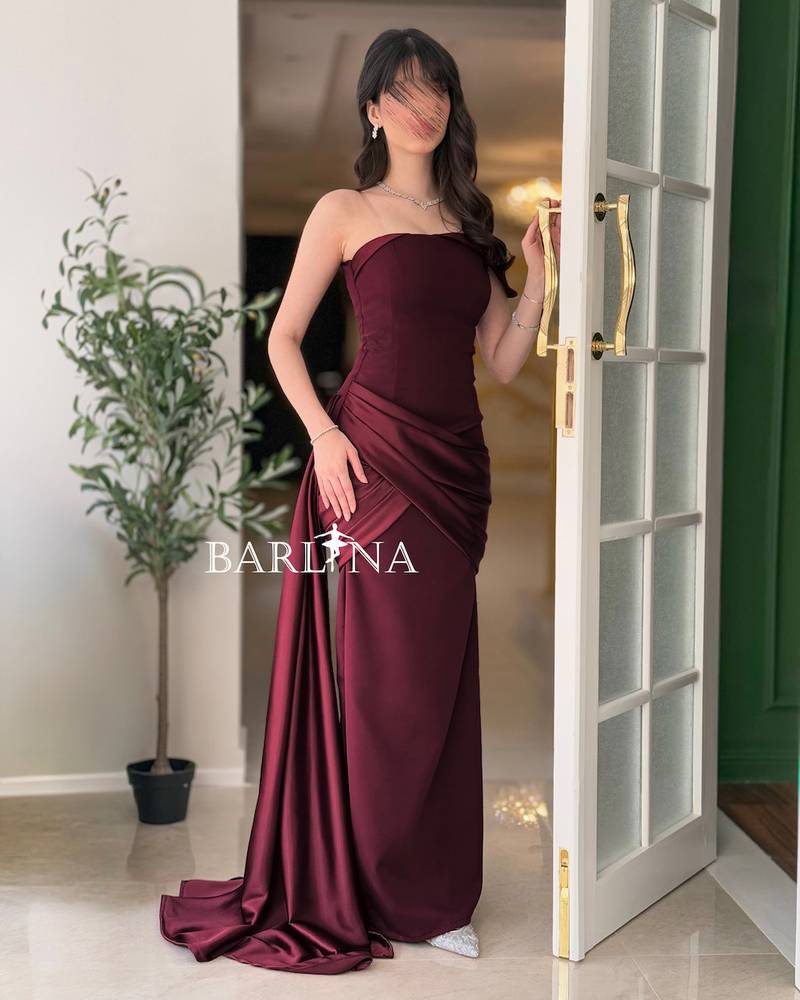 Burgundy dress with side draping and a long train