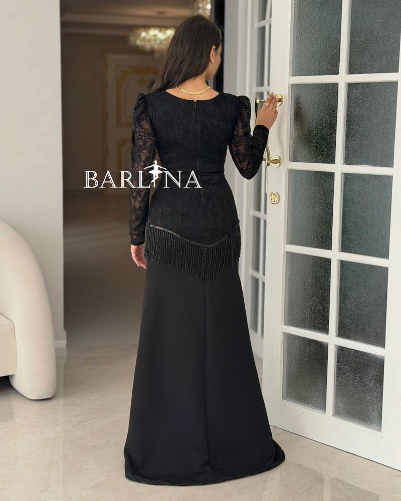 A soft black dress with lace and fringe details