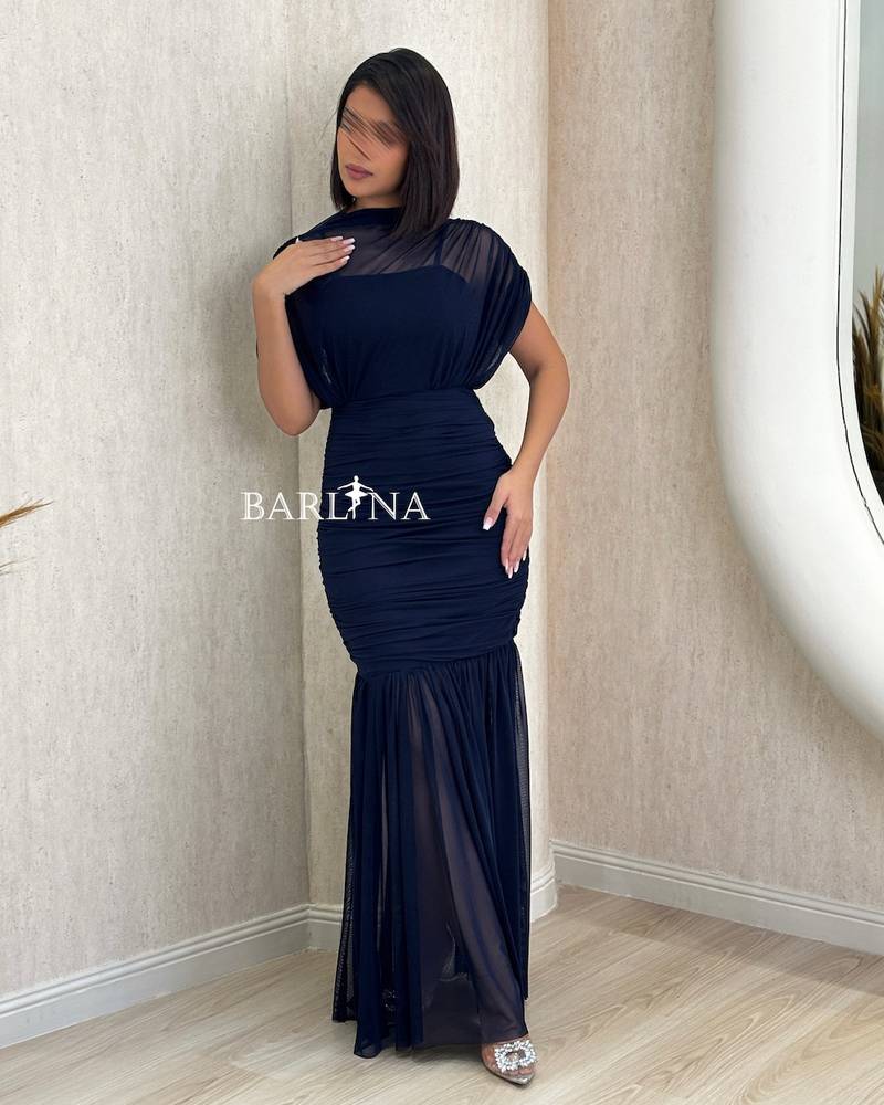 navy blue fitted dress with sheer layers at the bottom