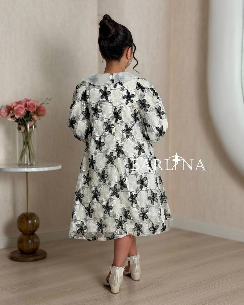 Off-white girl's dress decorated with black roses