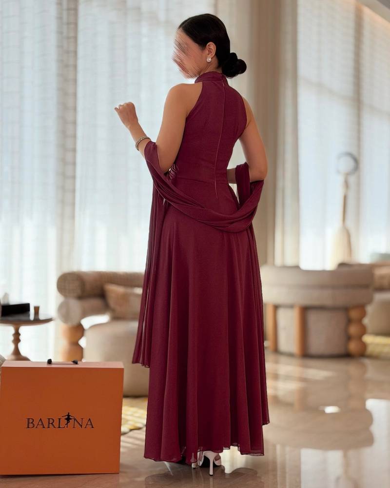 Burgundy dress with crisscross draping and a high neckline
