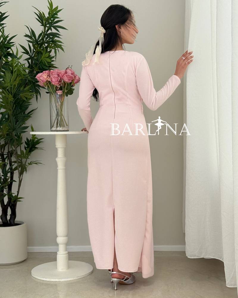 A soft pink dress with elegant details at the waist