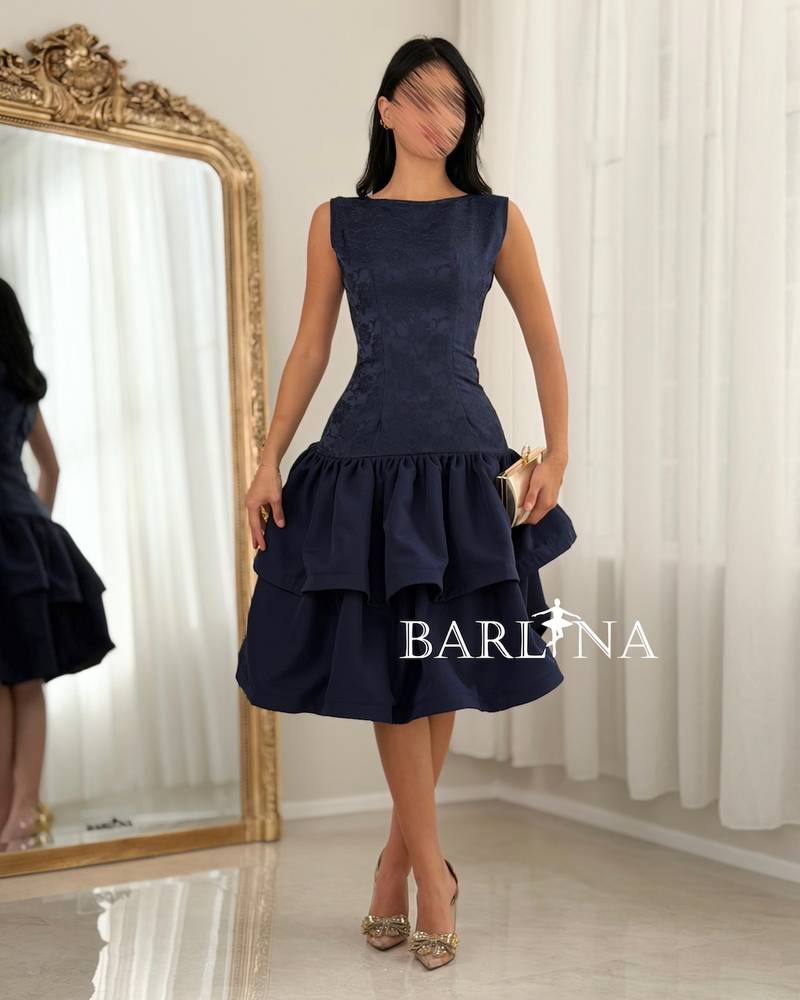 A soft dress with a low waist and layers of ruffles