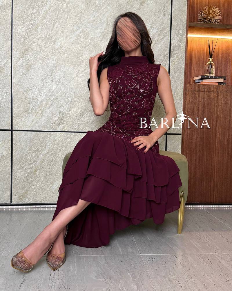 Dark burgundy dress embroidered with ruffles at the bottom