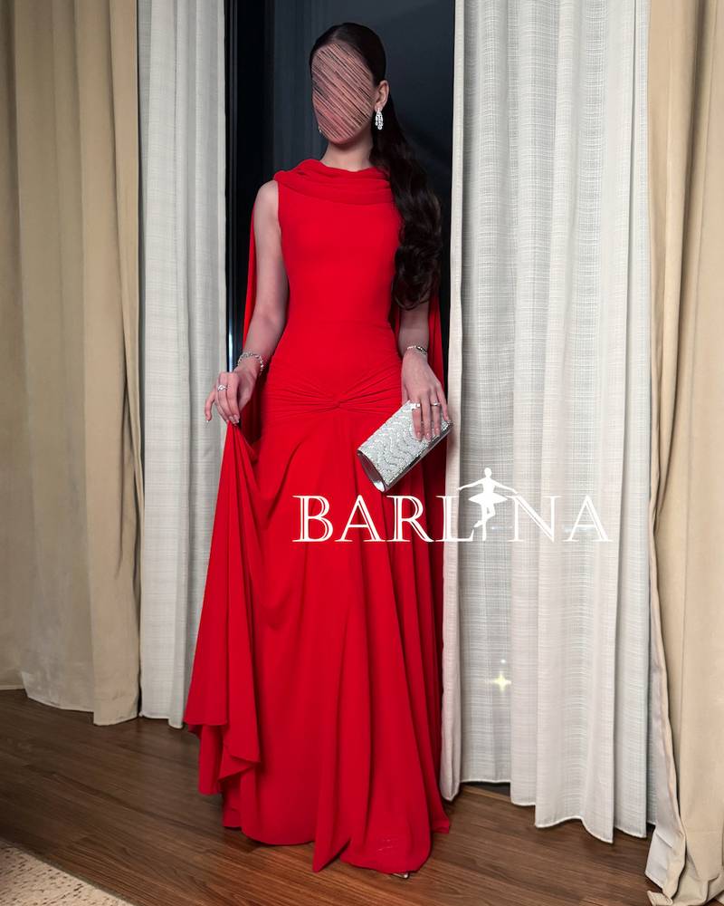 Red dress with a long cape falling from the shoulders