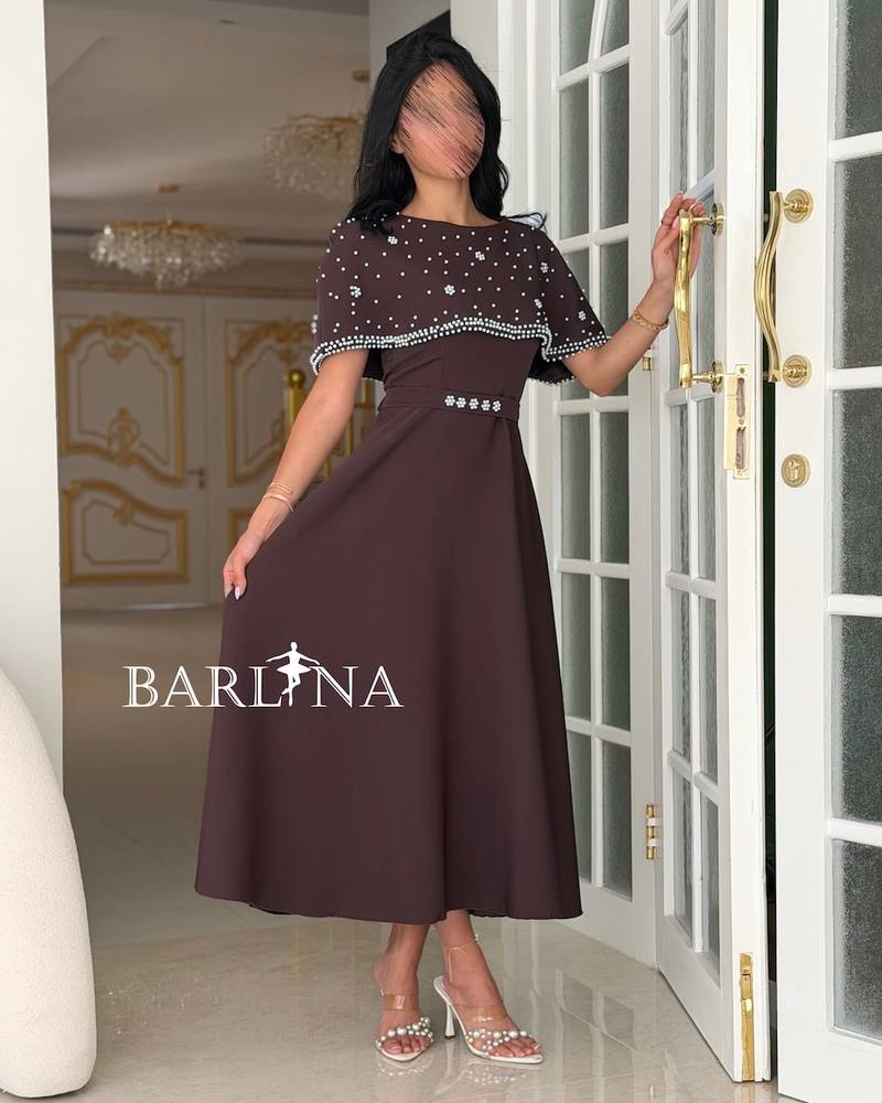 Brown dress with a crystal-embellished off-the-shoulder piece