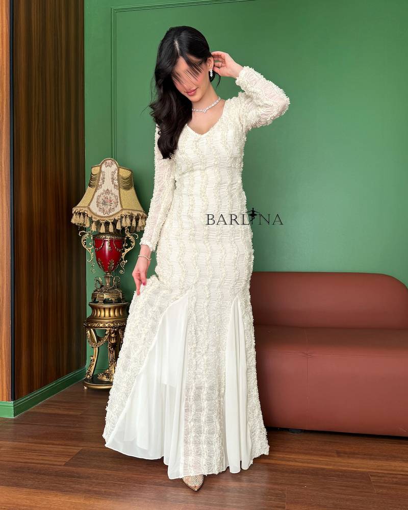 Long white dress with sheer sleeves and a flowing silhouette