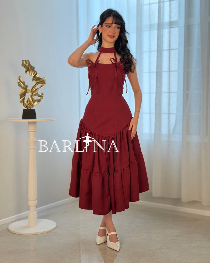A soft burgundy dress adorned with elegant bows