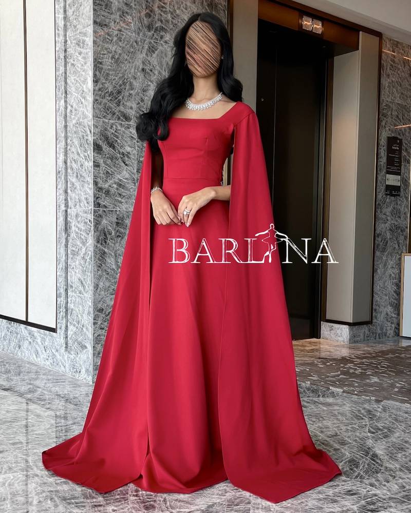 Soft red dress with long cape sleeves