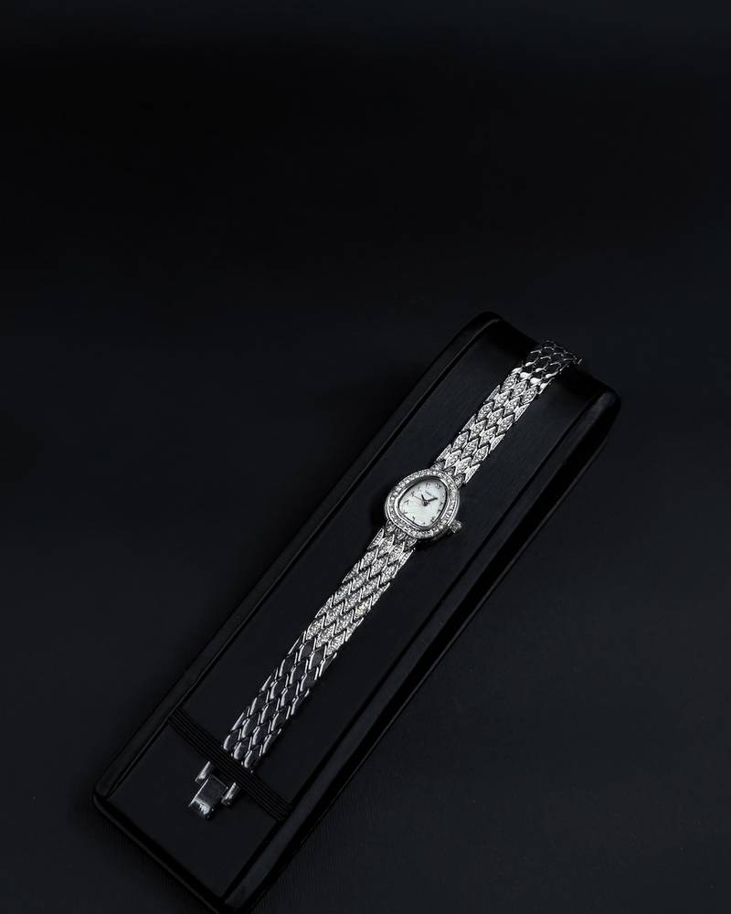 A luxury watch with a geometrically designed studded bracelet.