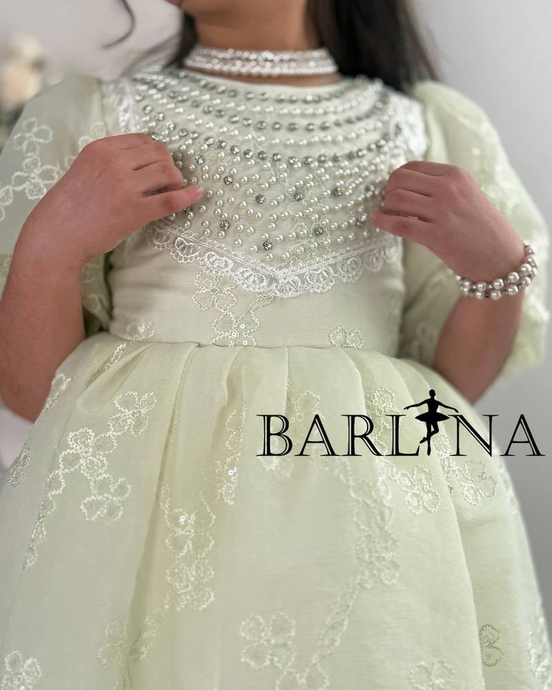 A soft, pearl-decorated girl's dress
