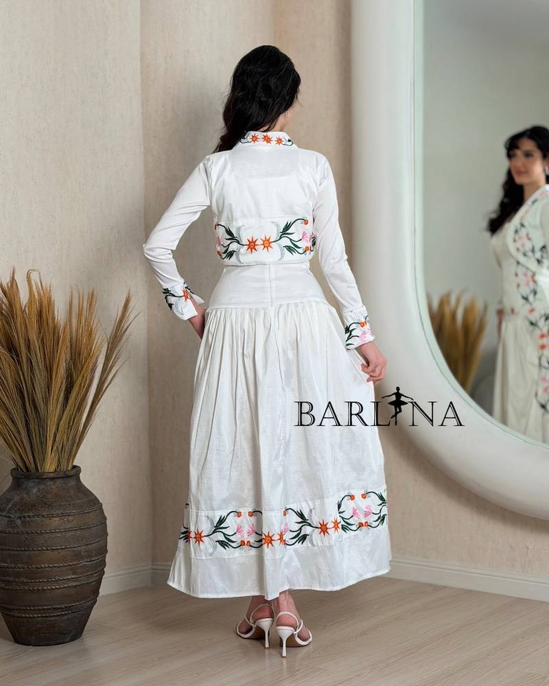A soft white dress with colorful floral embroidery