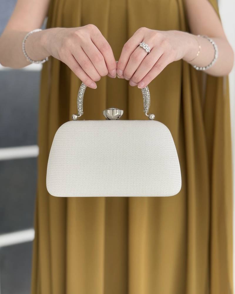 Gold evening bag with a metal frame and top lock