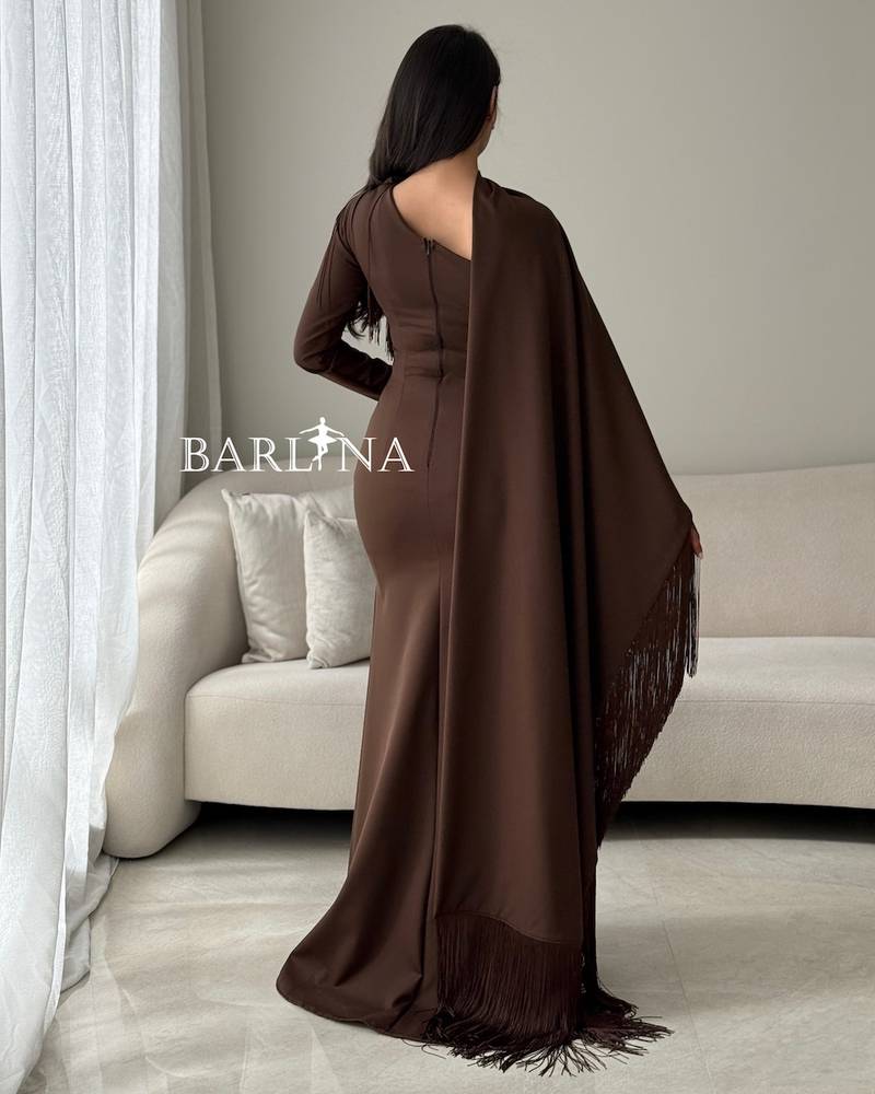 A brown dress with a wrapped cape adorned with fringes