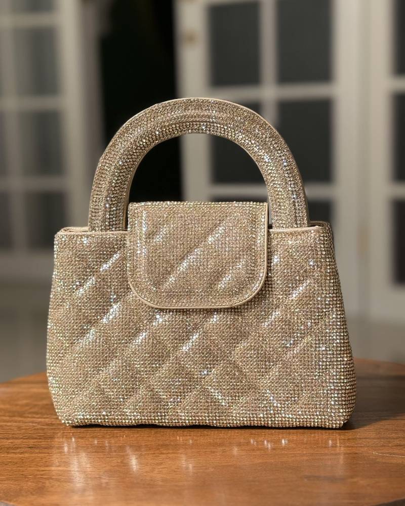 A square-shaped handbag with a stylish wide handle.