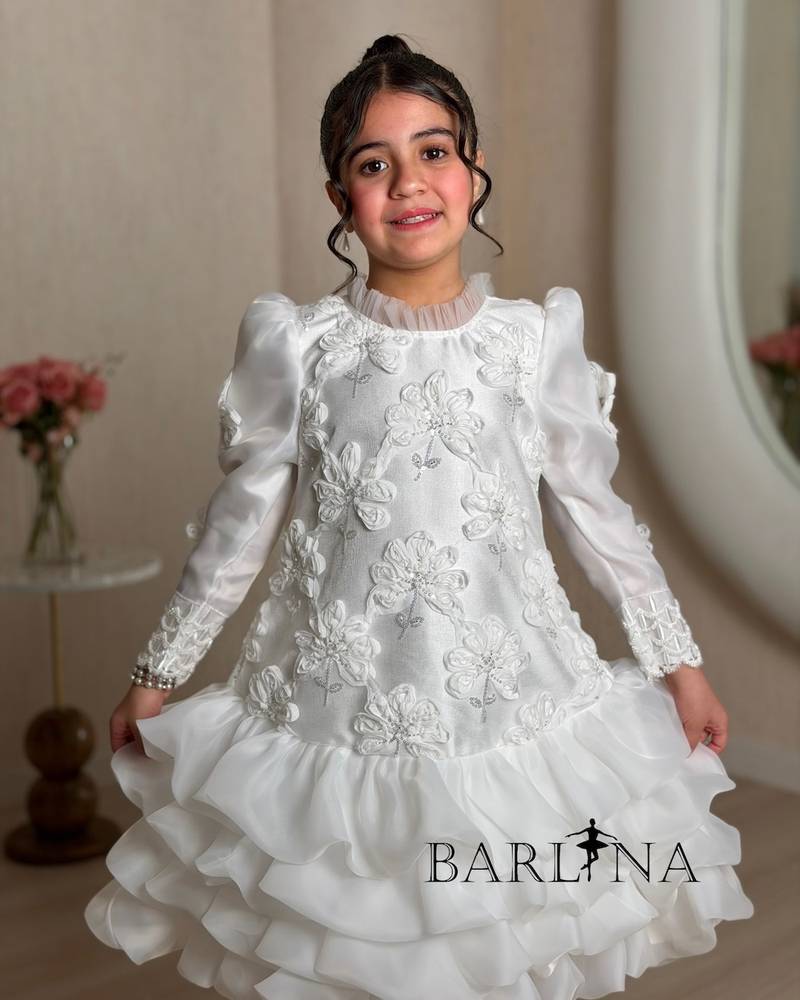A white girl's dress decorated with raised roses