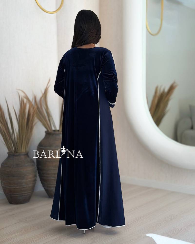 A navy blue flared jalabiya decorated with crystals