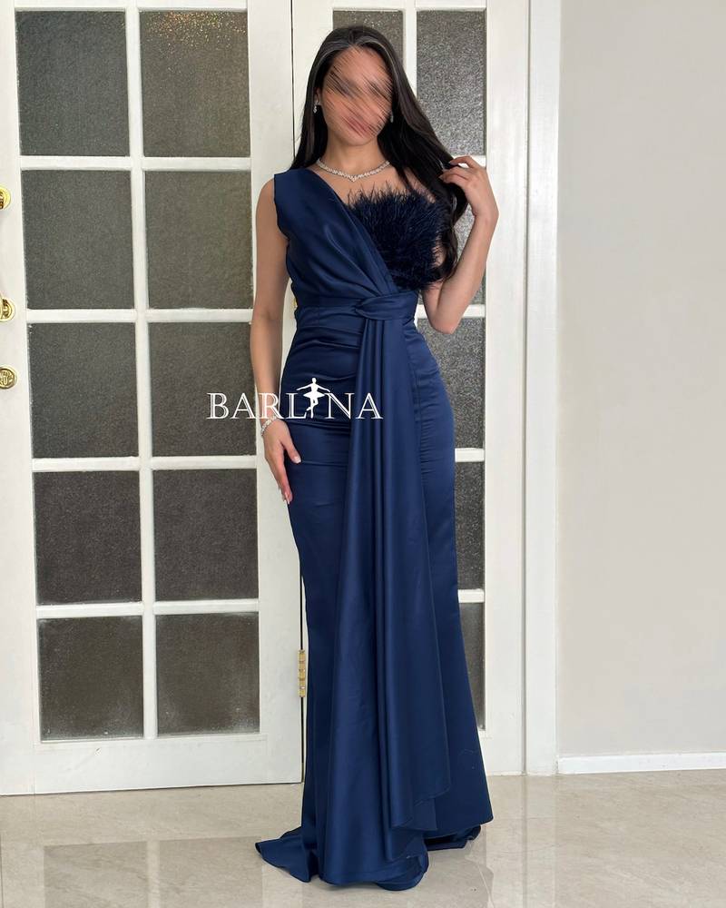 A soft navy dress with delicate feather details at the chest.