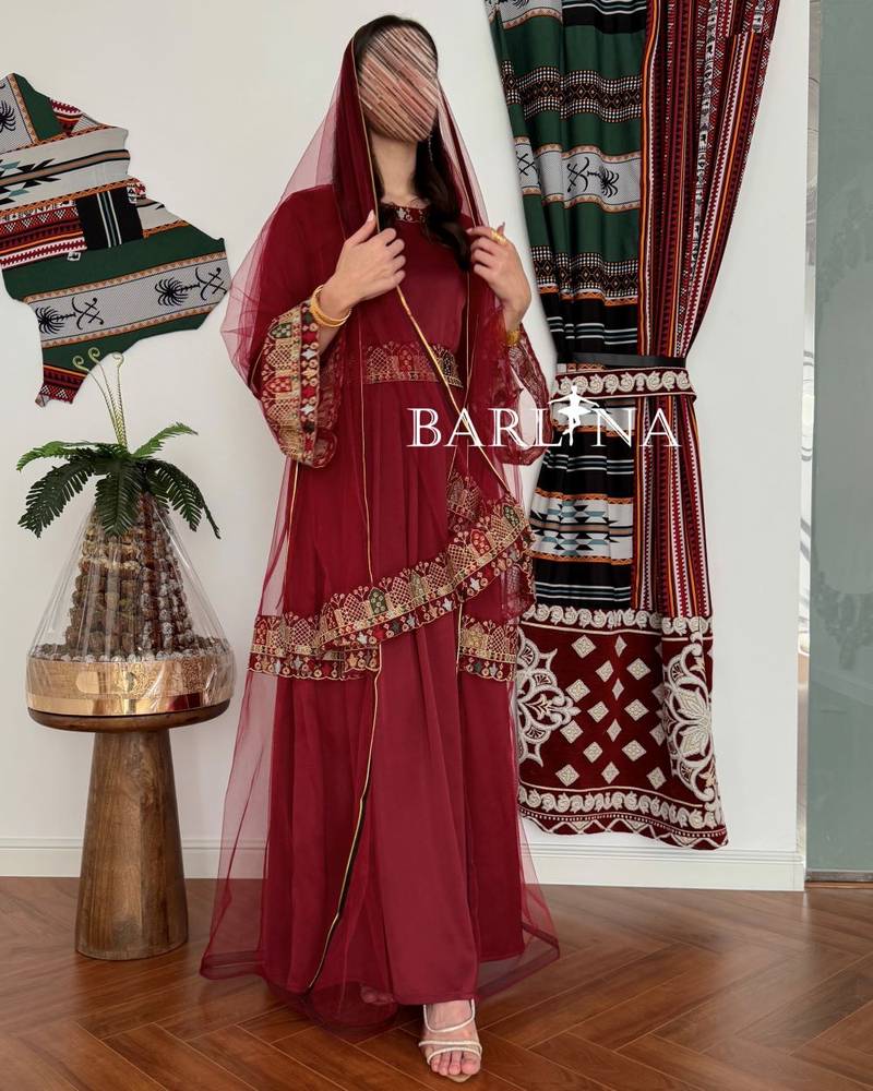 Maroon jalabiya decorated with colorful embroidery