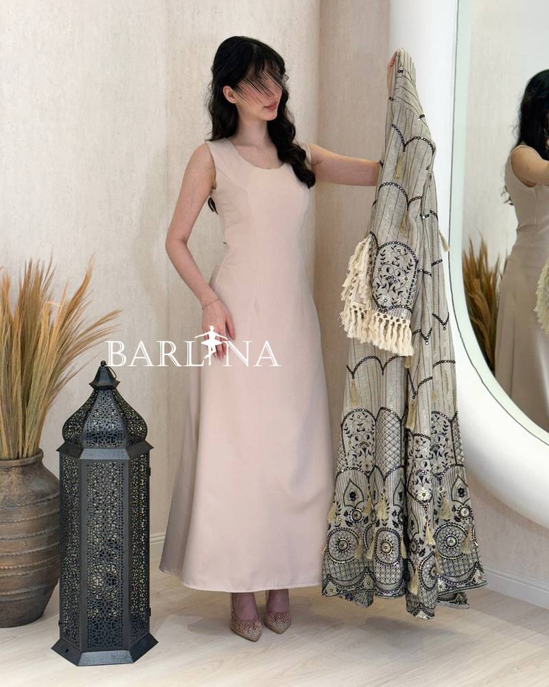 A jalabiya with a geometric pattern in shades of beige and black.