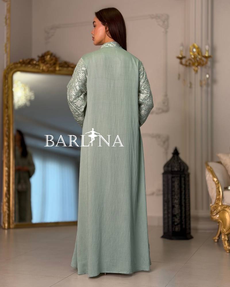 A green jalabiya decorated with full embroidery