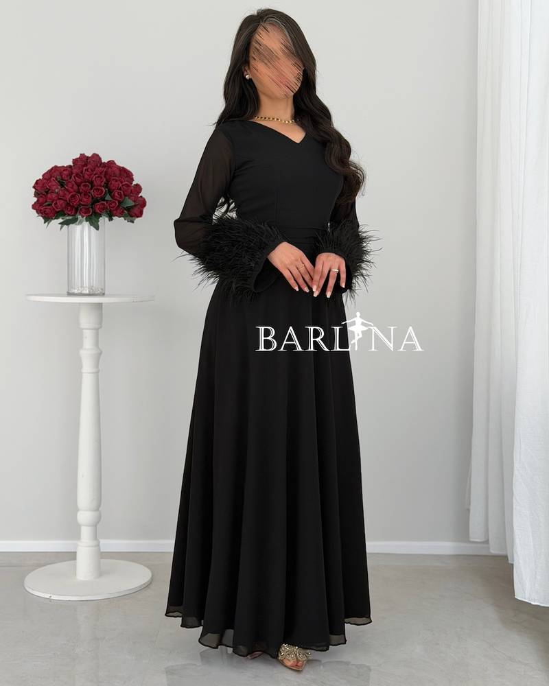 Classic black dress with feathered sleeves