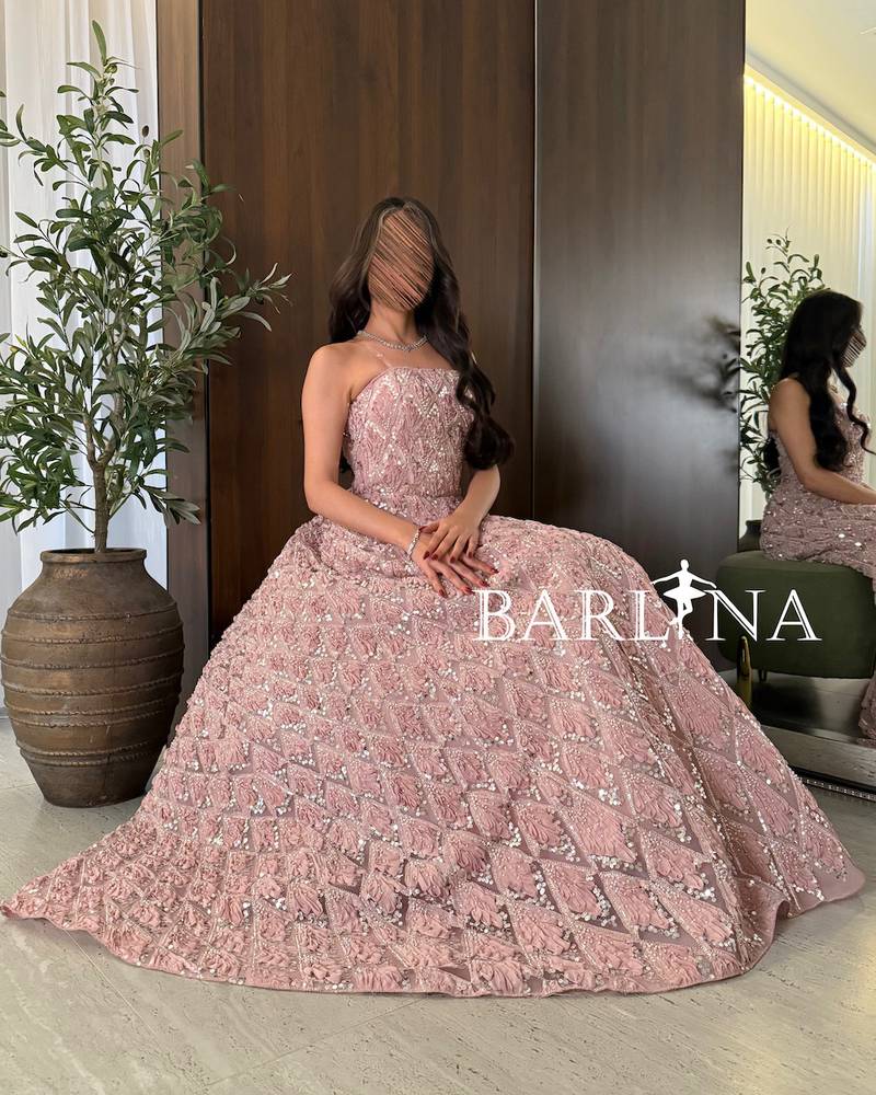 Pink evening dress with shiny embroidery and a geometric pattern