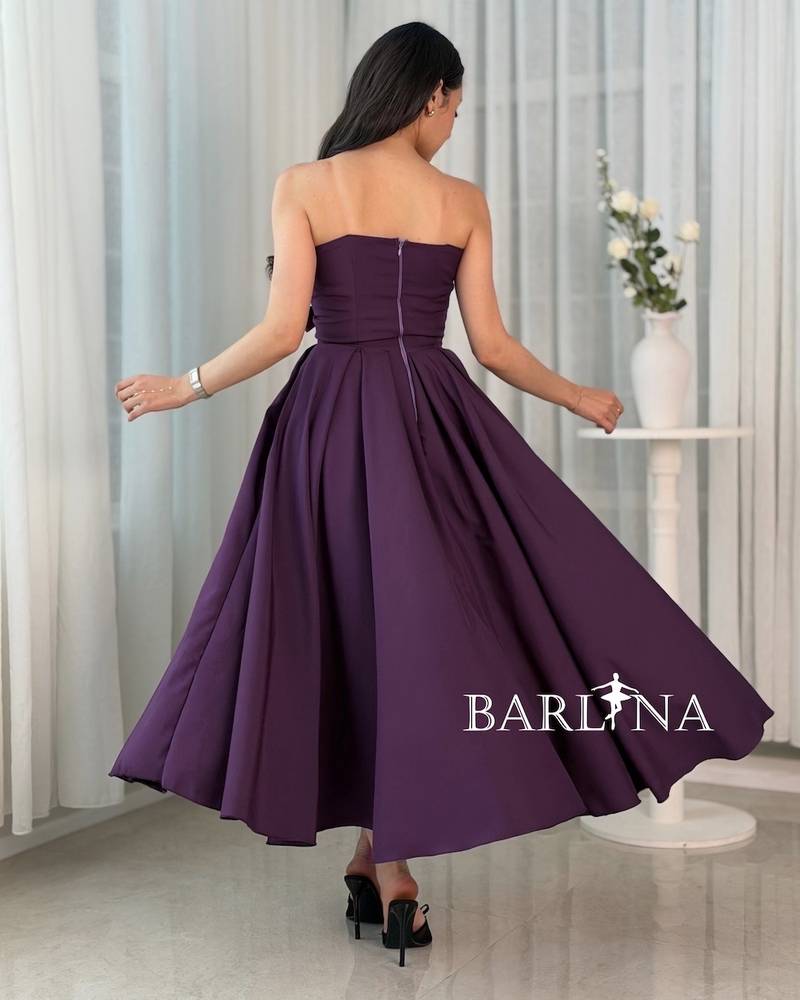 A purple dress with a simple cut and side details.