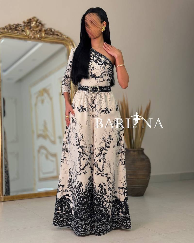 Black and white one-shoulder jumpsuit with an artistic pattern