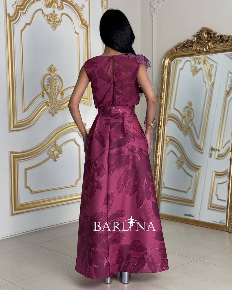 Elegant fuchsia dress with a prominent rose on the shoulder