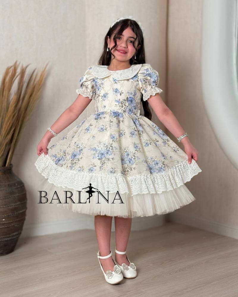 A classic off-white girl's dress with a floral print