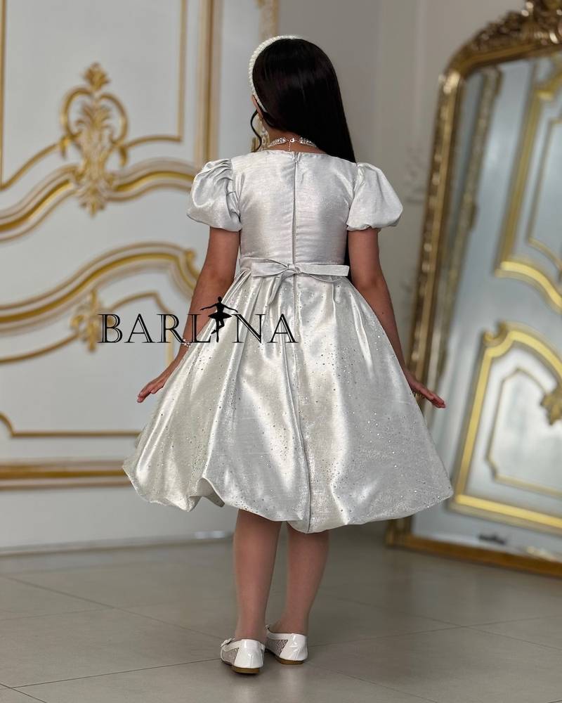 Elegant girl's dress with a bow on the chest