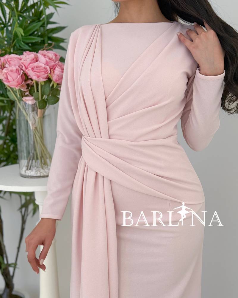 A soft pink dress with elegant details at the waist