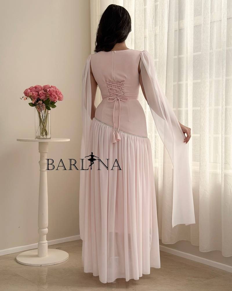 Pastel pink dress with a shawl over the shoulders