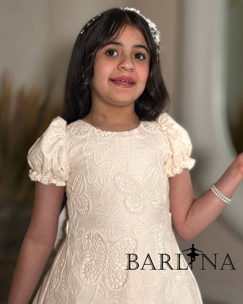 Beige girls' dress with butterfly print fabric