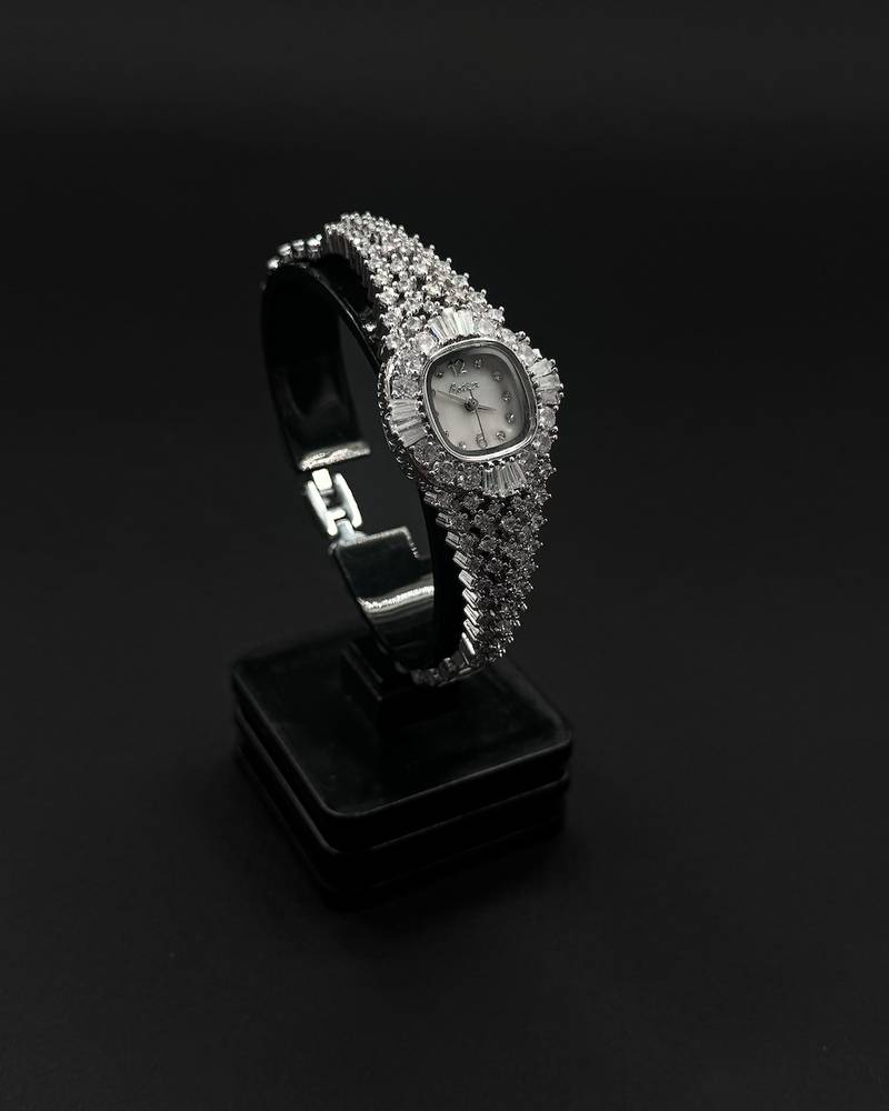 A luxury wristwatch fully encrusted with sparkling stones