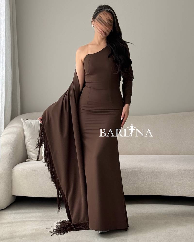 A brown dress with a wrapped cape adorned with fringes